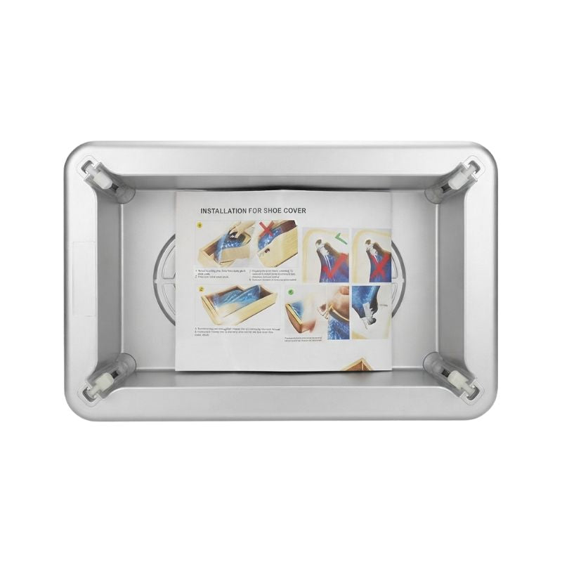 Top-down view of the automatic shoe cover dispenser containing the included instruction manual for easy setup.