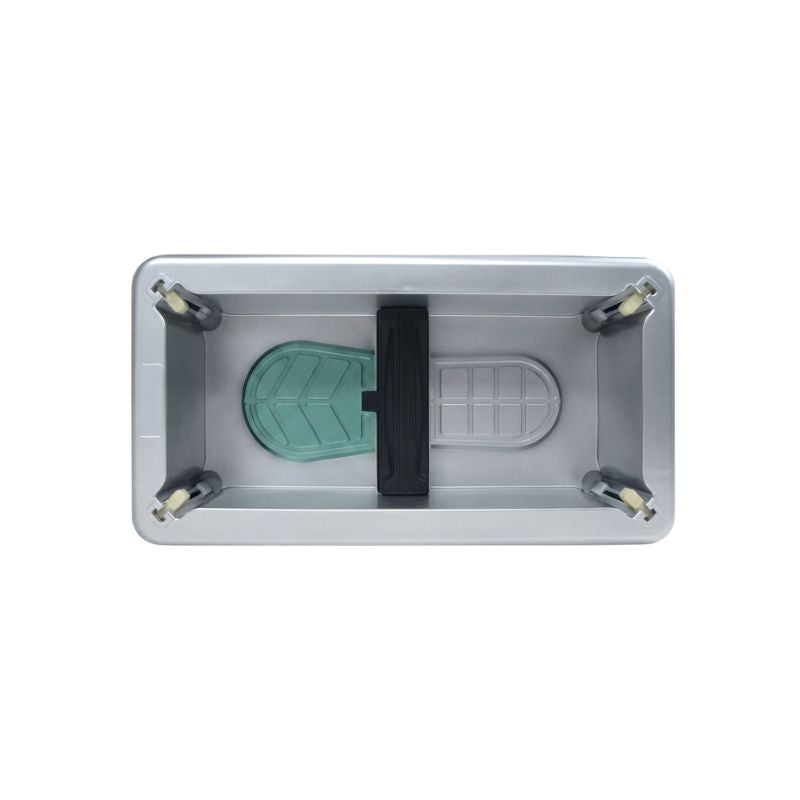 Internal bottom frame view of the automatic shoe cover dispenser showing foot placement guides and mechanical pedal slot