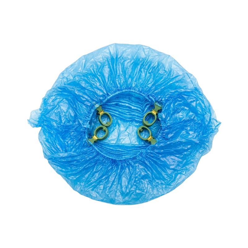 Top-down view of a single blue disposable shoe cover featuring four secure T-clips for mechanical dispenser compatibility.