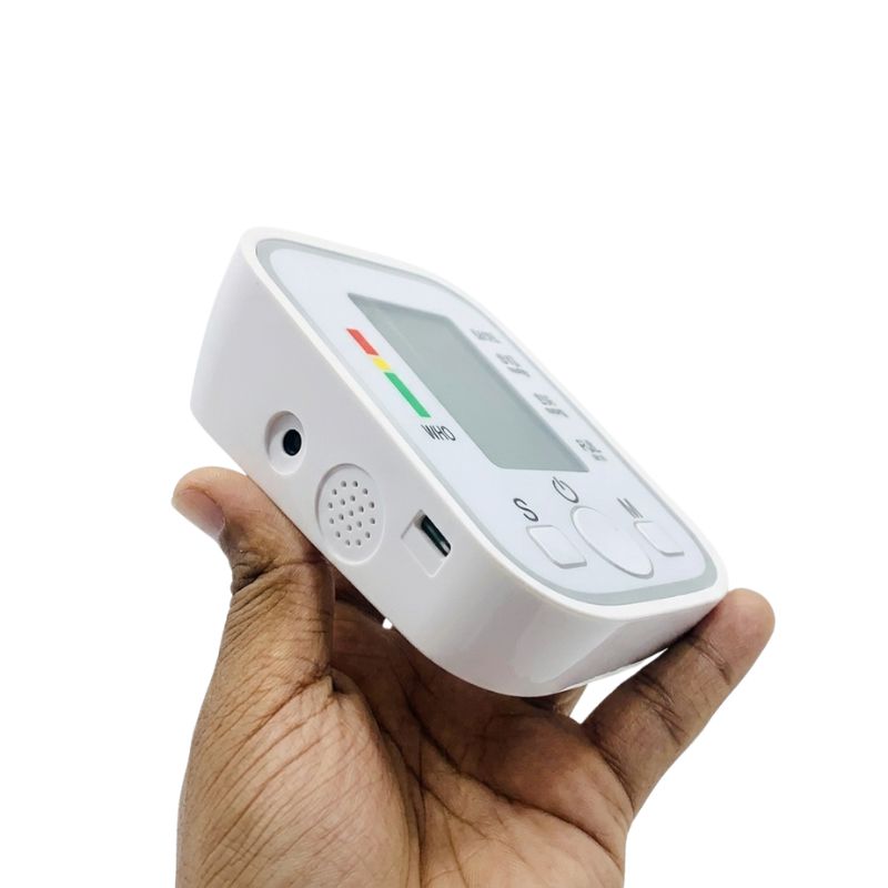 Side profile view of a doctor bp machine showing the cuff tubing port, power port, and built-in speaker grill.
