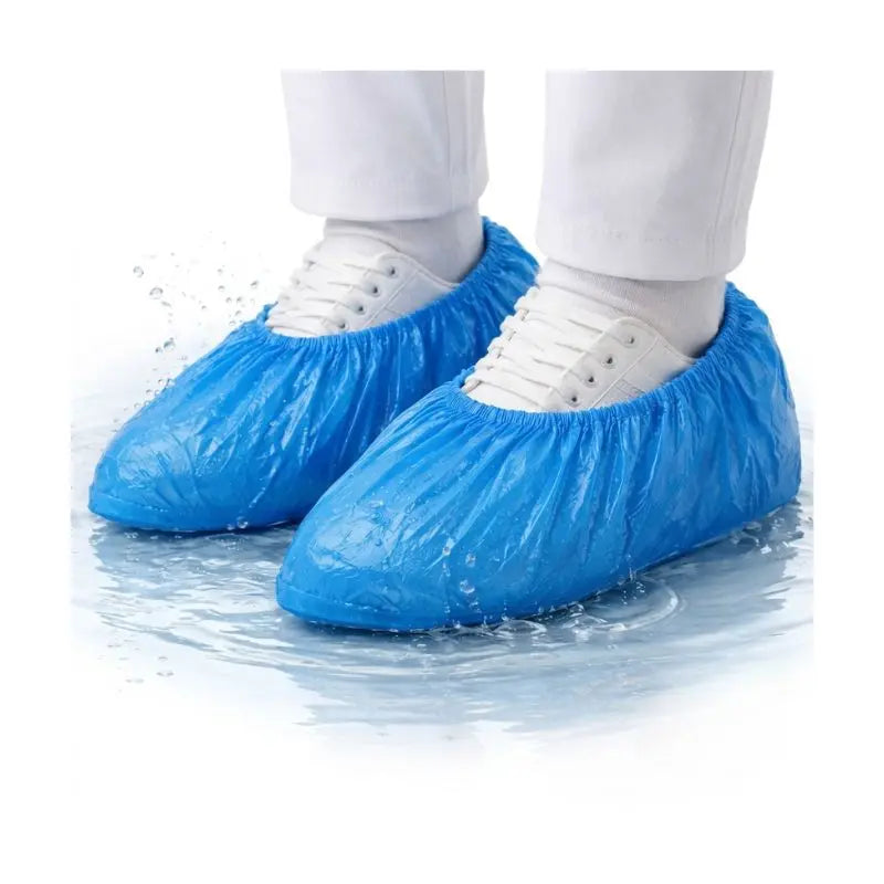 Waterproof plastic shoe cover worn over white sneakers splashing in water, highlighting waterproof performance and durable protection.